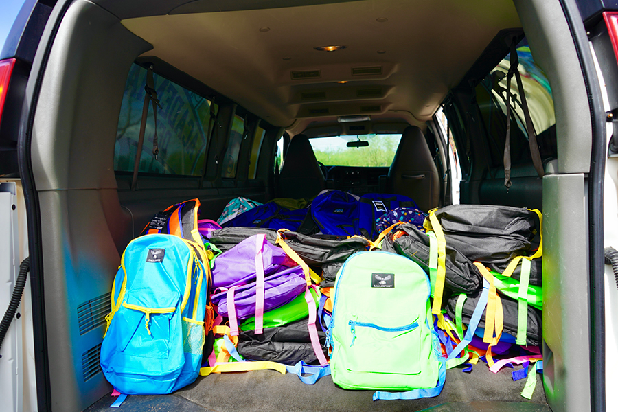 a van filled with donated backpacks