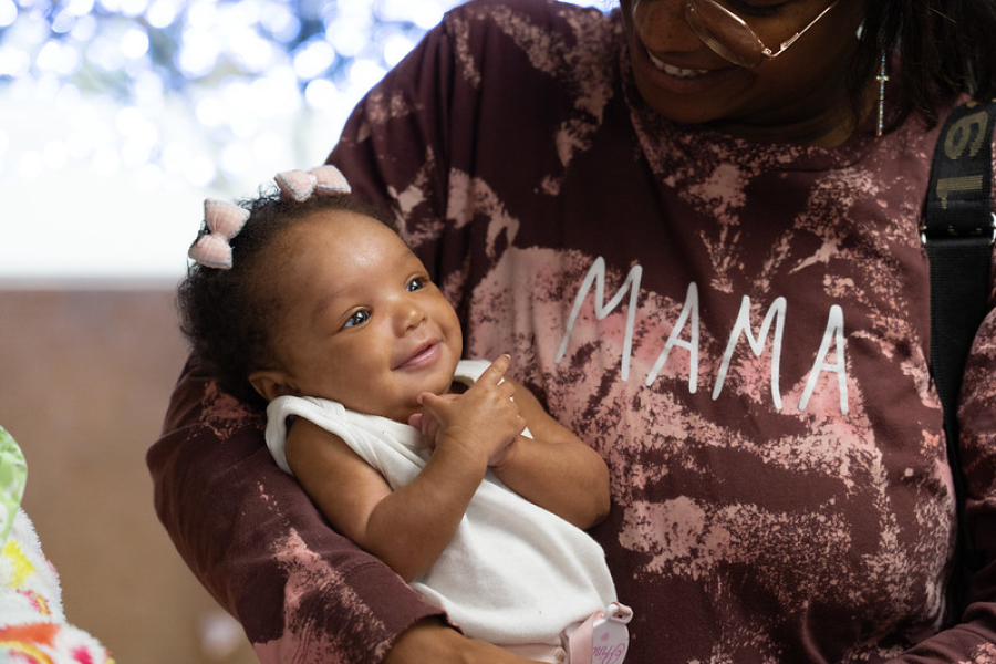 mom holding smiling baby