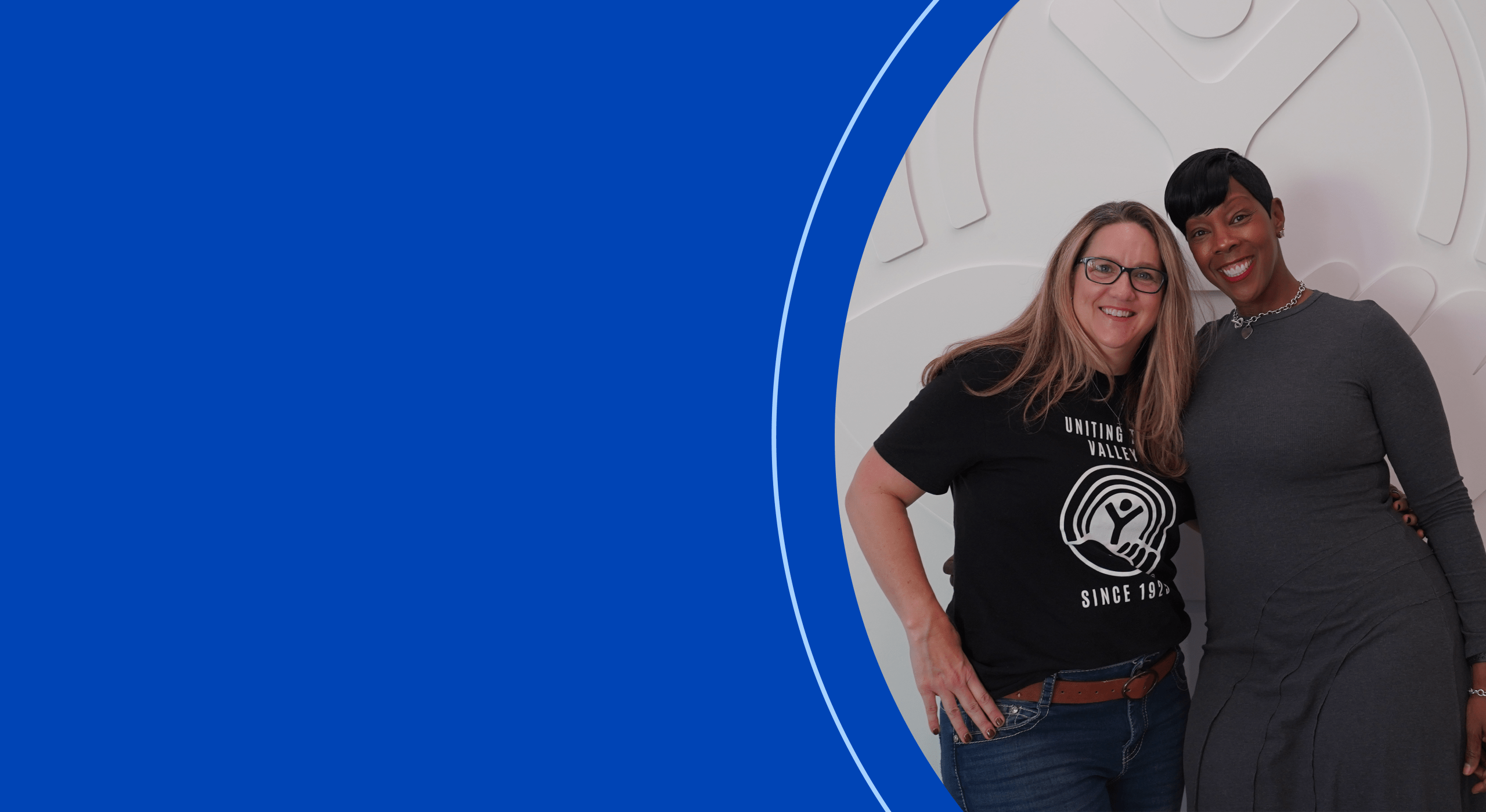 two employees posing for a photo