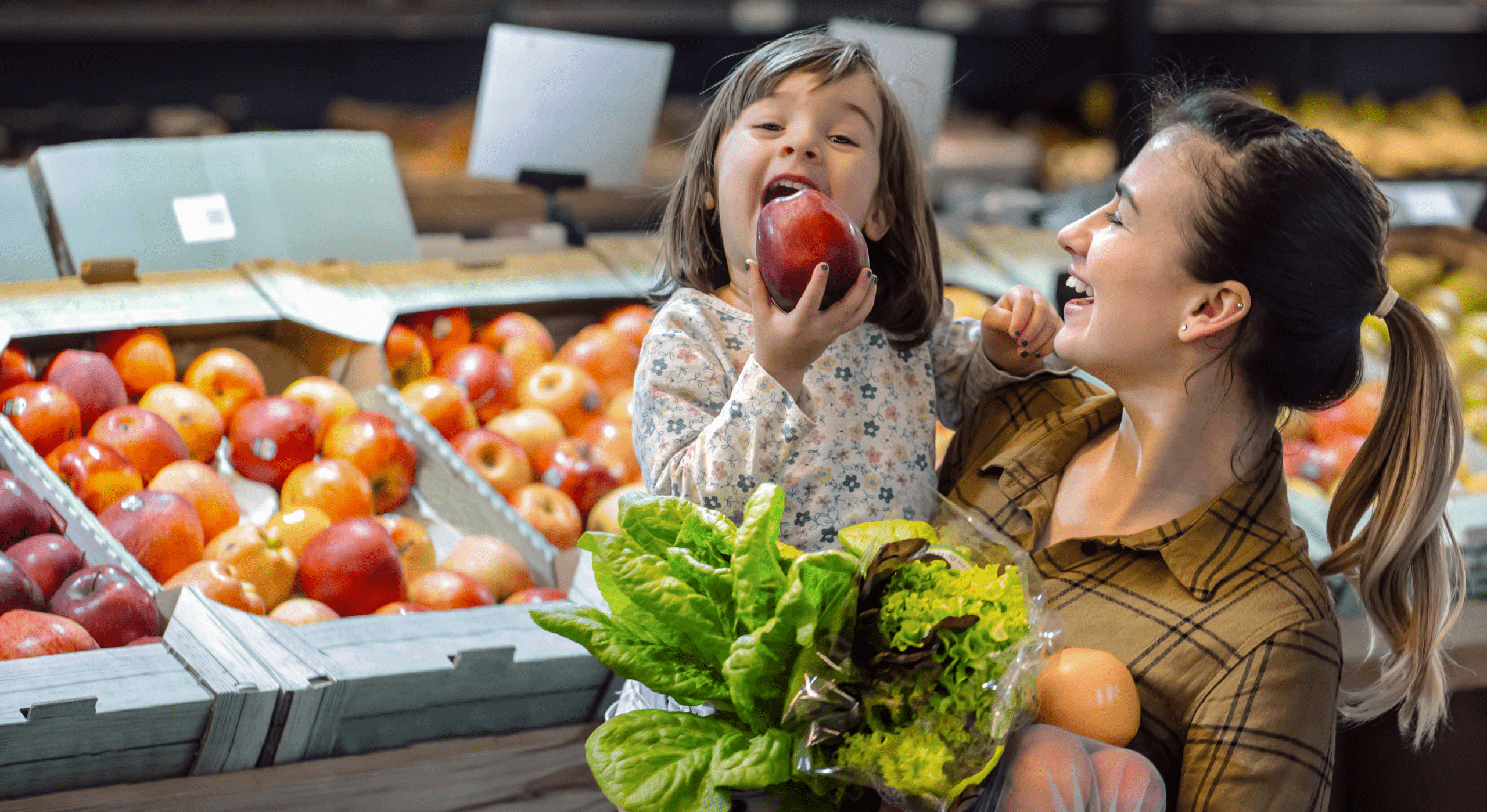 mother holding child with apple
