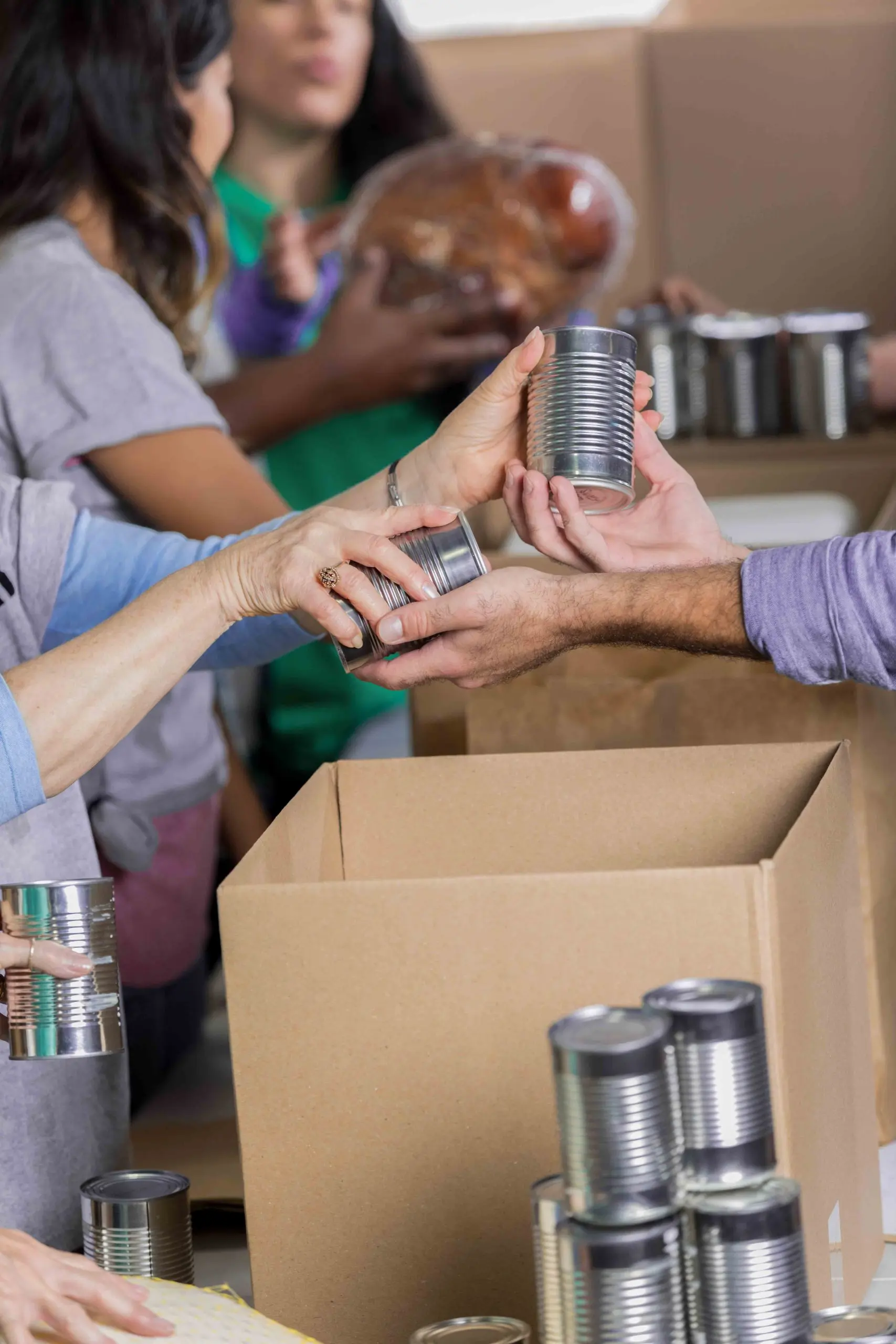 hands passing a can of food