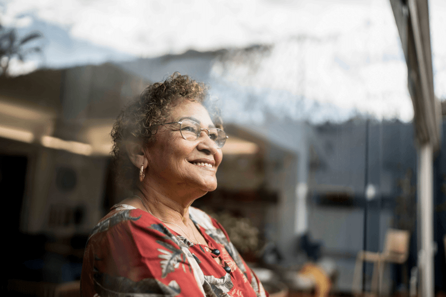 woman looking out window smiling