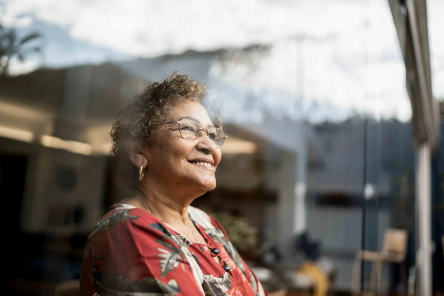 woman looking out window smiling